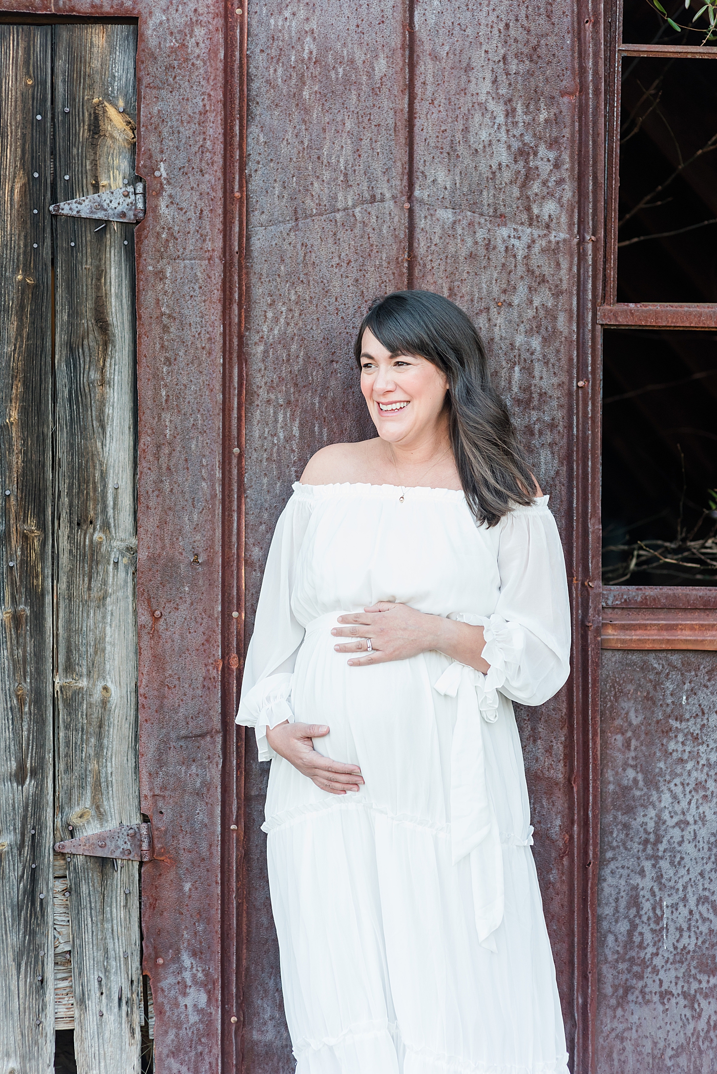 Expecting mother in white dress | Photo by Anna Wisjo Photography