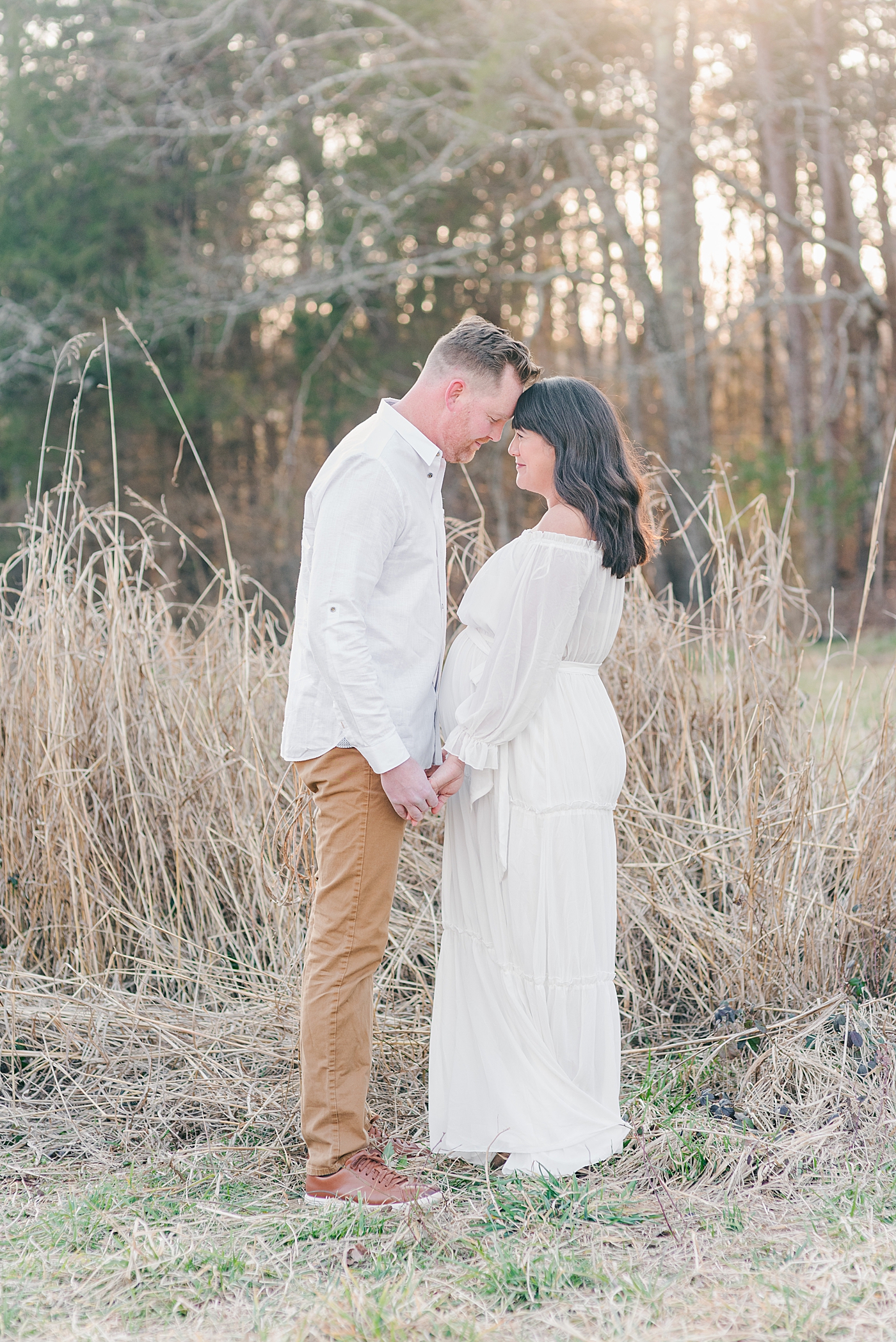 Mom and dad to be with foreheads together at fisher farm park | Photo by Anna Wisjo Photography
