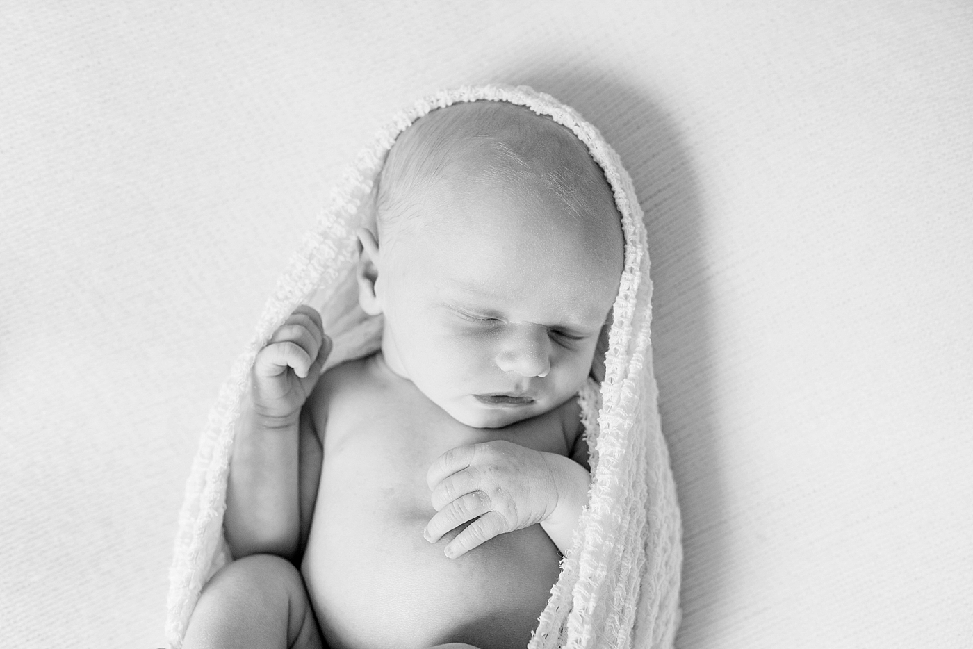Black and white photo of newborn baby wrapped in a soft swaddle during Denver NC Newborn Session | Photo by Anna Wisjo Photography