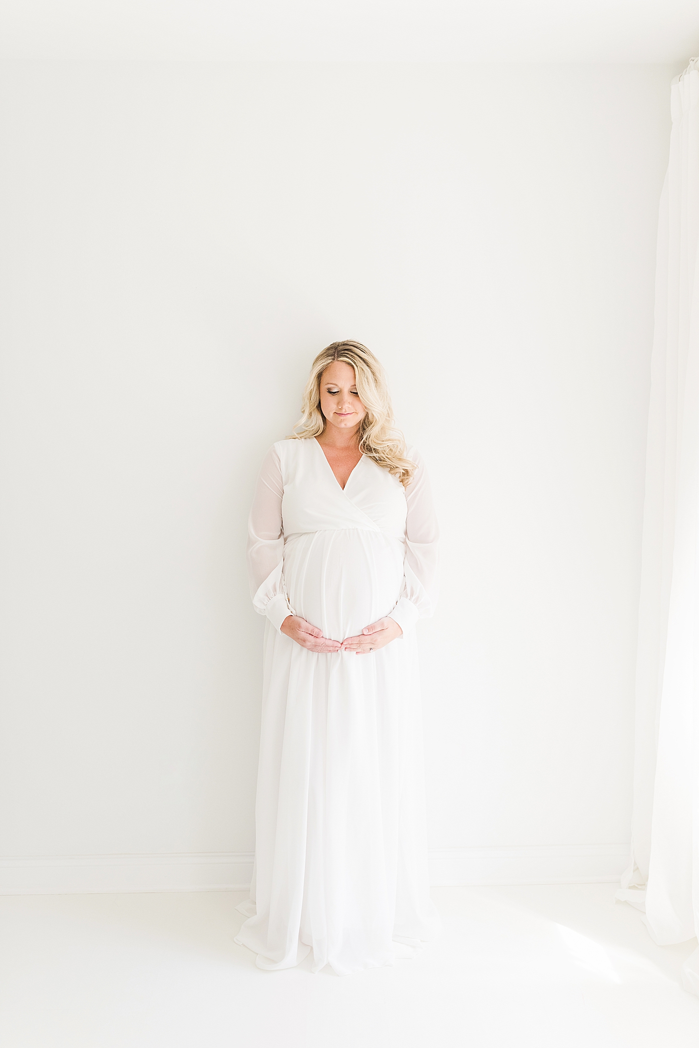 Mother to be in white dress | Photo by Anna Wisjo Photography