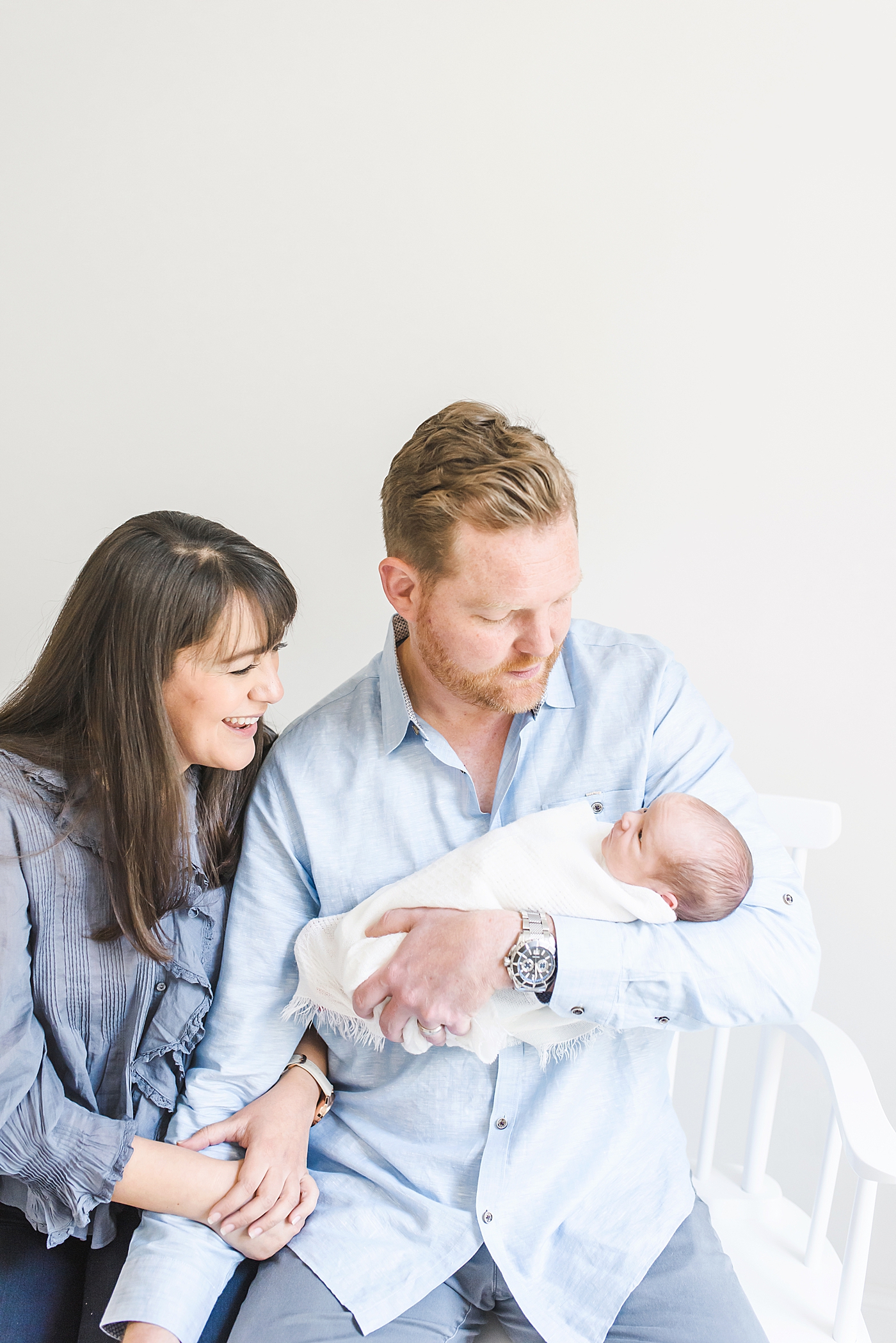 Mom and dad smiling at newborn baby boy | Photo by Denver NC Newborn Photographer Anna Wisjo 