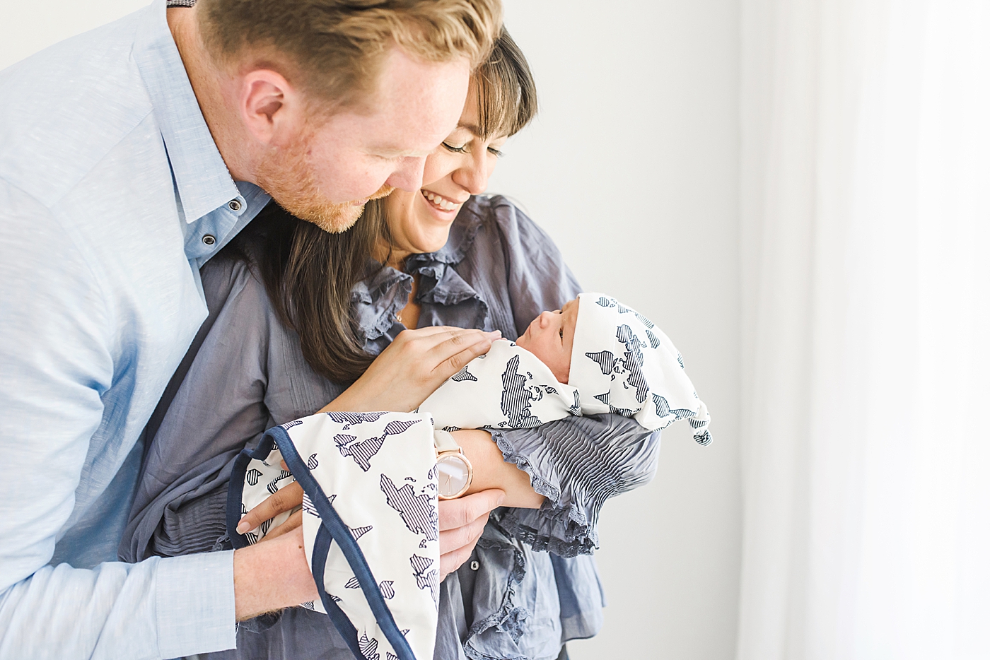 Mom and dad in blue with newborn baby boy | Photo by Denver NC Newborn Photographer Anna Wisjo 
