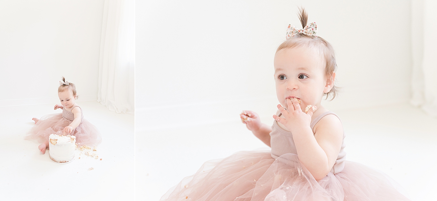Baby girl in pink tutu eating cake | Photo by Anna Wisjo Photography