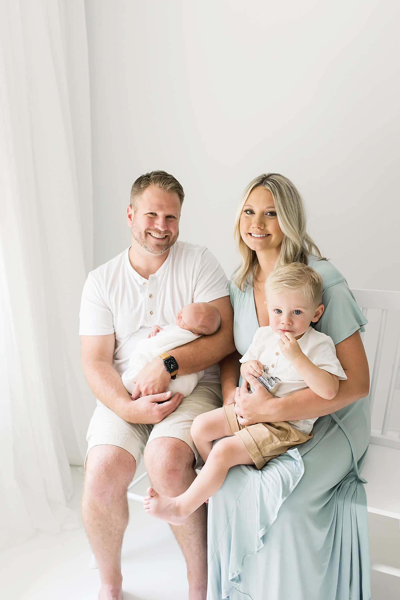 Mom and dad holding toddler and newborn baby girl |Photo by Huntersville NC Newborn Photographer Anna Wisjo