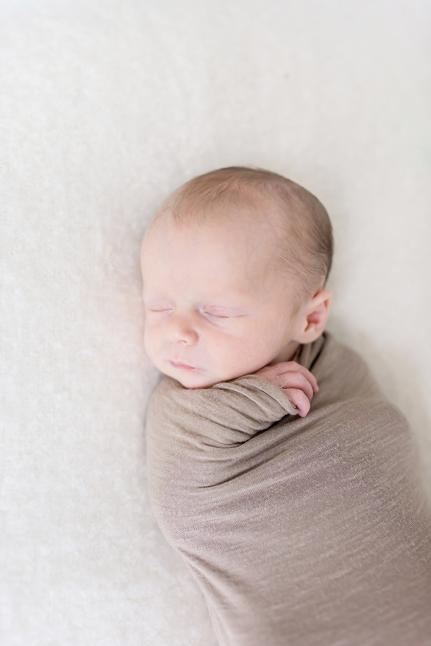 Baby boy sleeping wrapped in a swaddle | Photo by Charlotte NC Newborn Photographer Anna Wisjo
