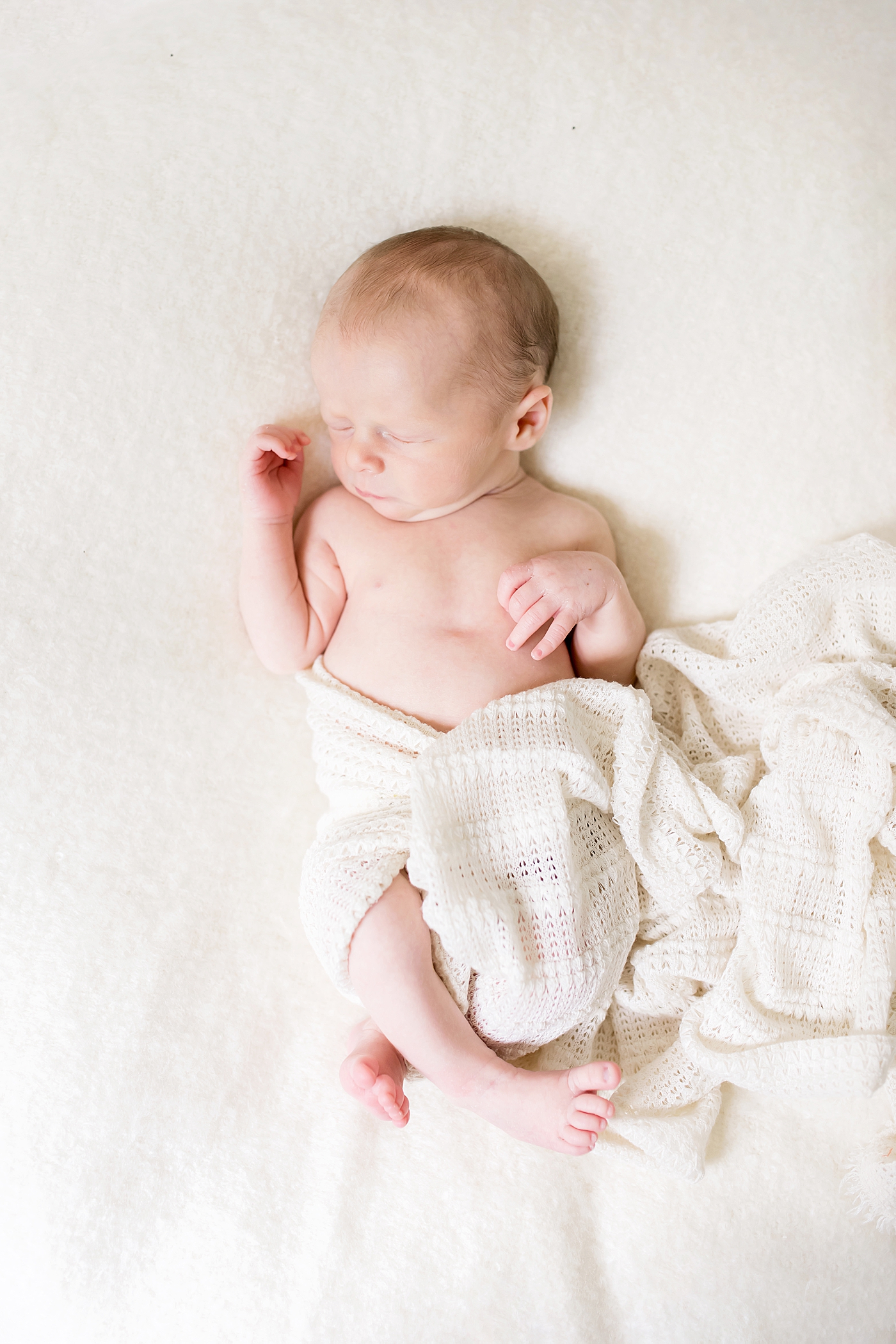 Newborn baby wrapped in cream swaddle | Photo by Charlotte NC Newborn Photographer Anna Wisjo