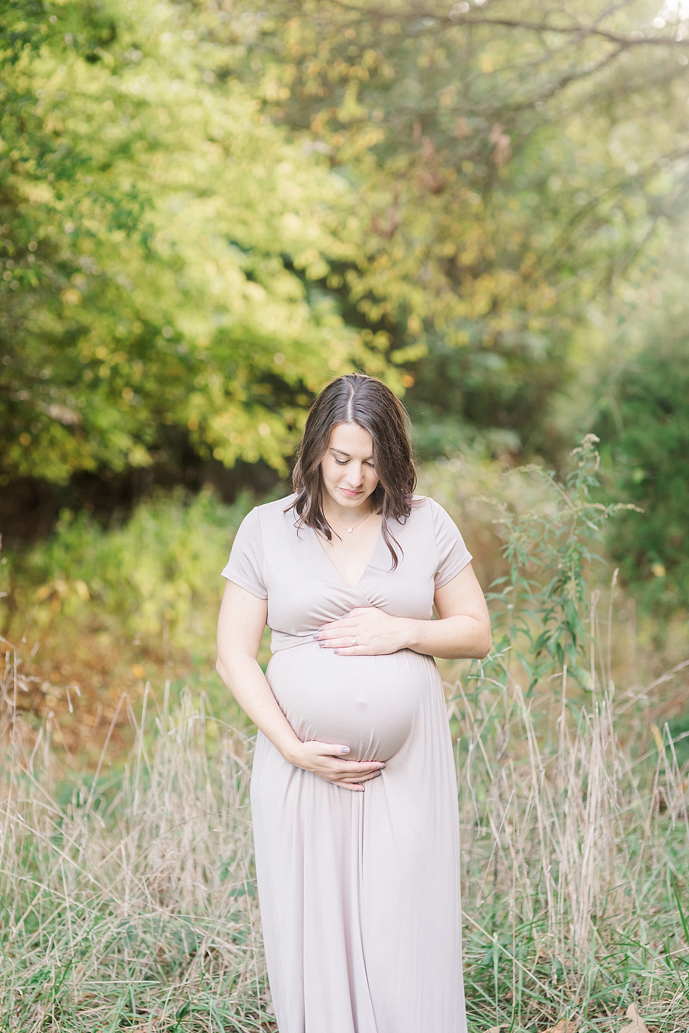 Mom to be admiring her belly | Photo by Davidson Maternity Photographer Anna Wisjo