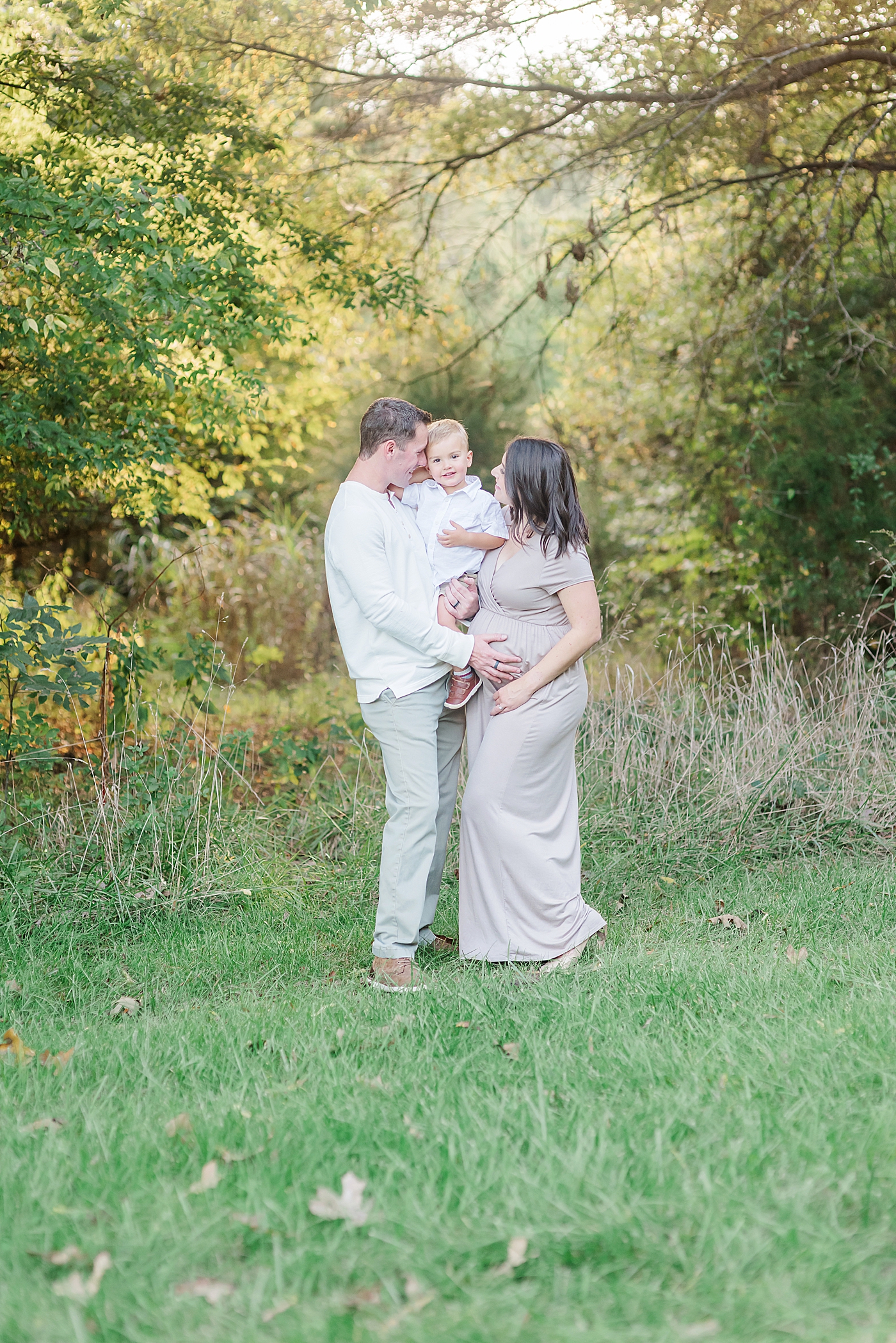 Mom and dad smiling at toddler son | Photo by Davidson Maternity Photographer Anna Wisjo