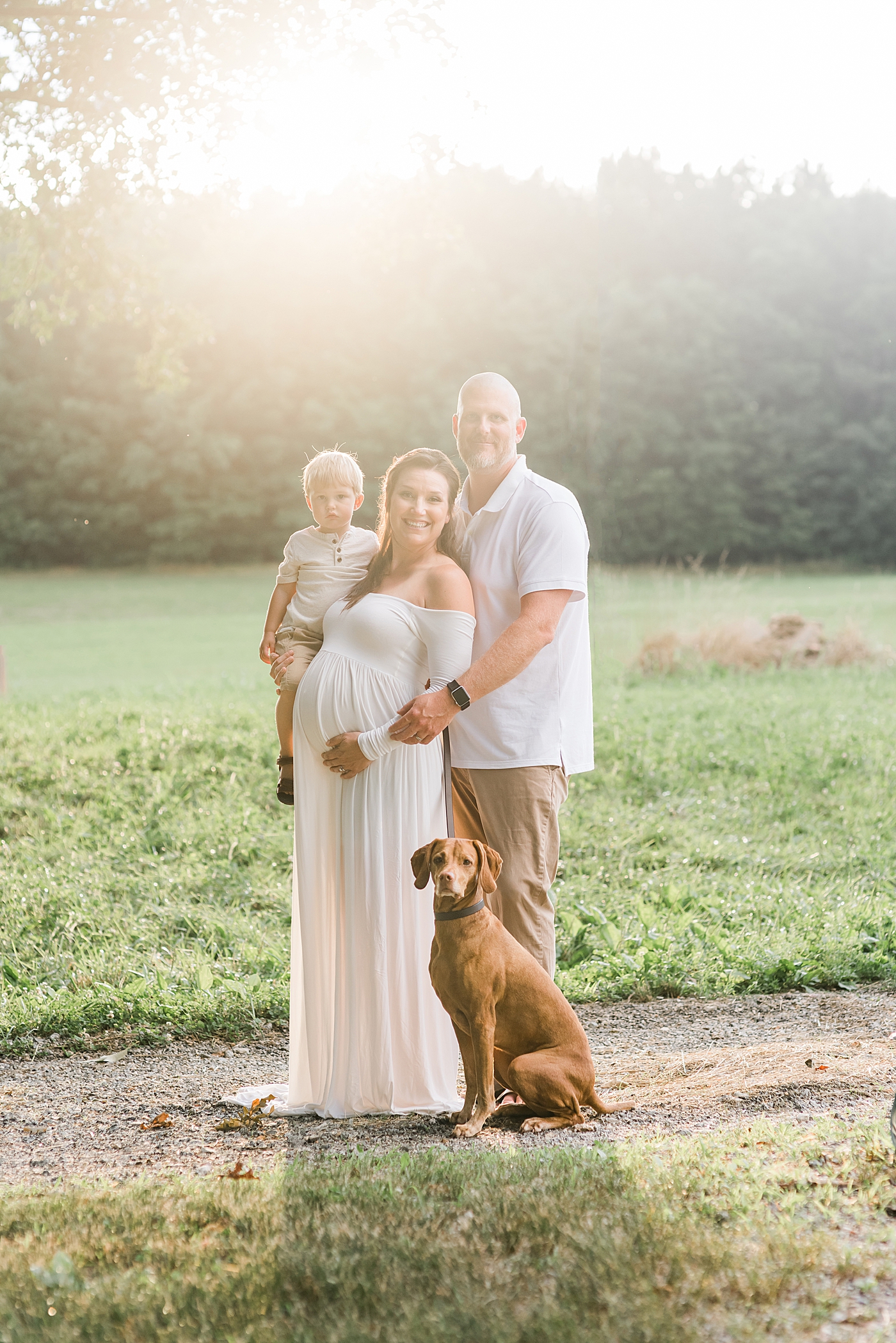 Mom, dad, and little boy with their dog | Photo by Anna Wisjo Photography