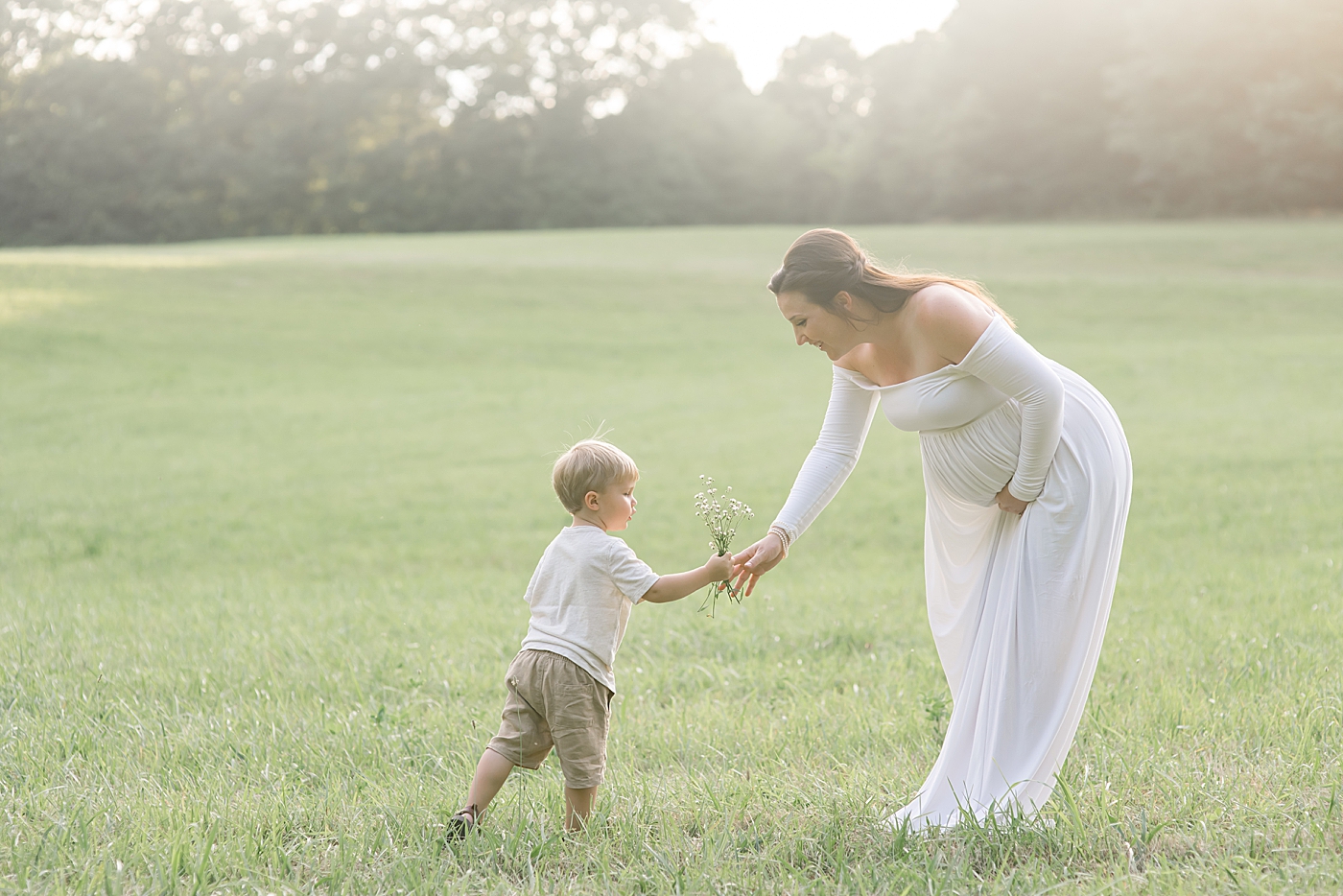 Toddler boy giving mom foraged flowers | Photo by Denver NC Maternity Photographer Anna Wisjo