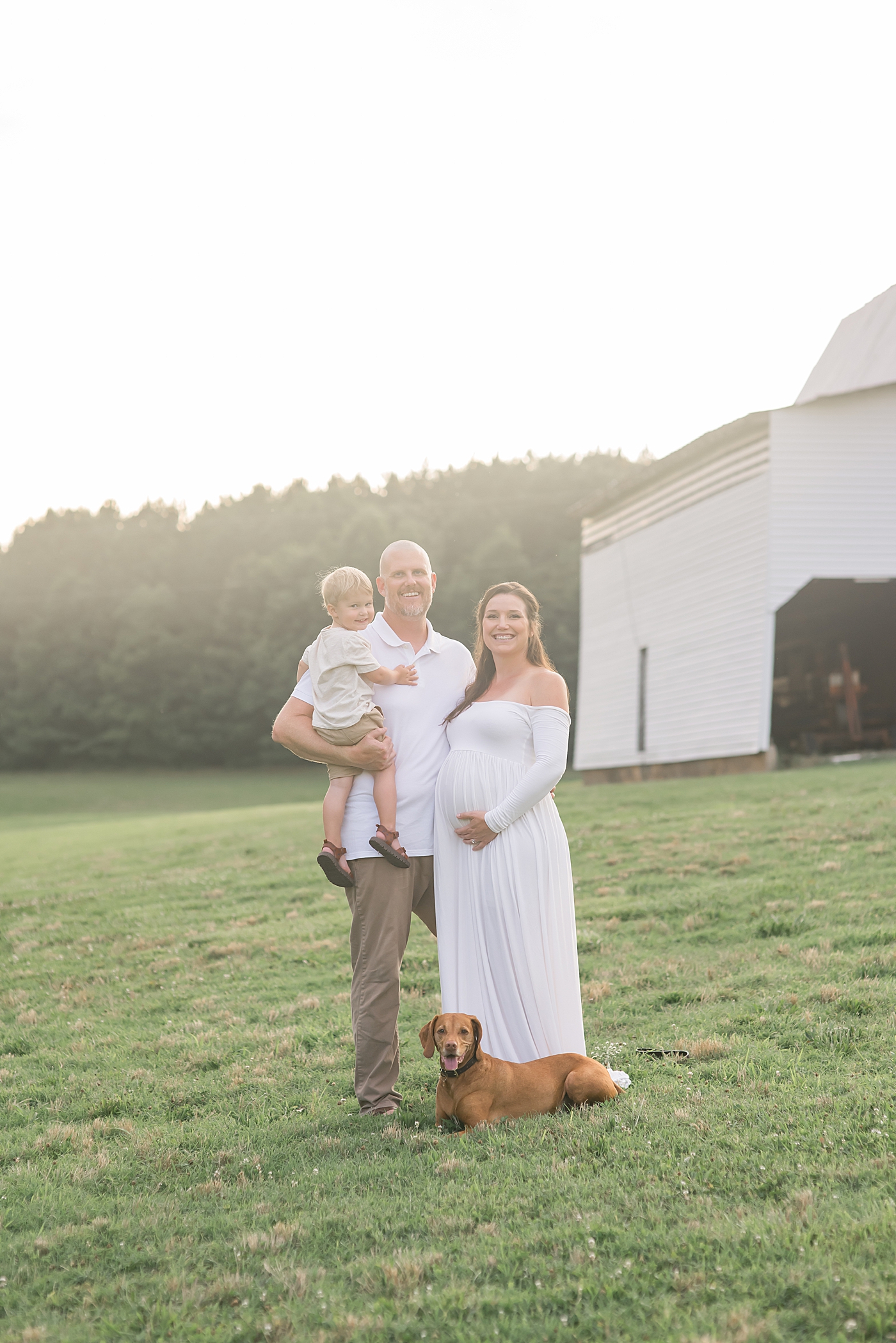 Mom, dad, and toddler boy with their dog | Photo by Anna Wisjo Photography