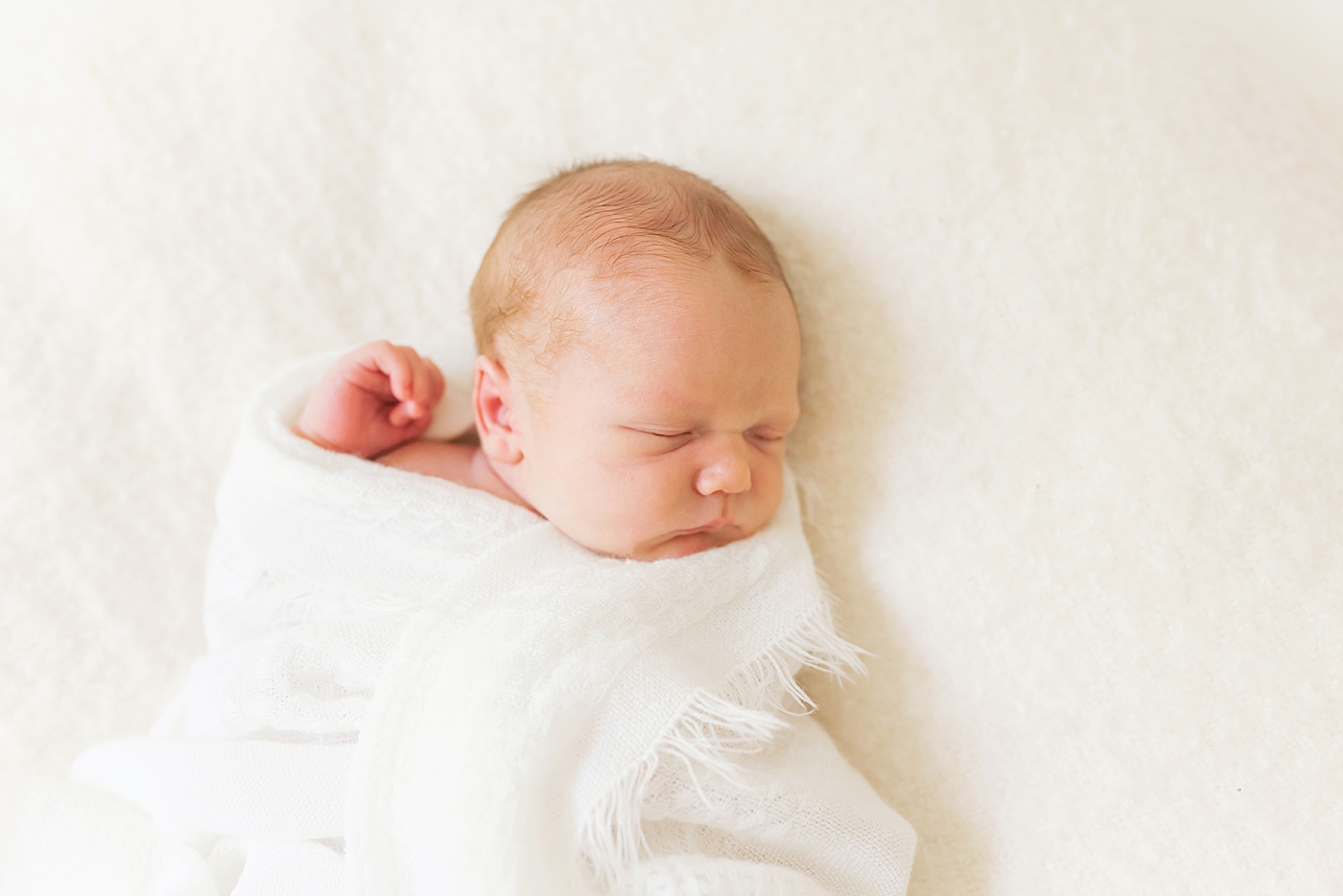 Newborn wrapped in white blanket | Photo by Denver NC Newborn Photographer Anna Wisjo Photography