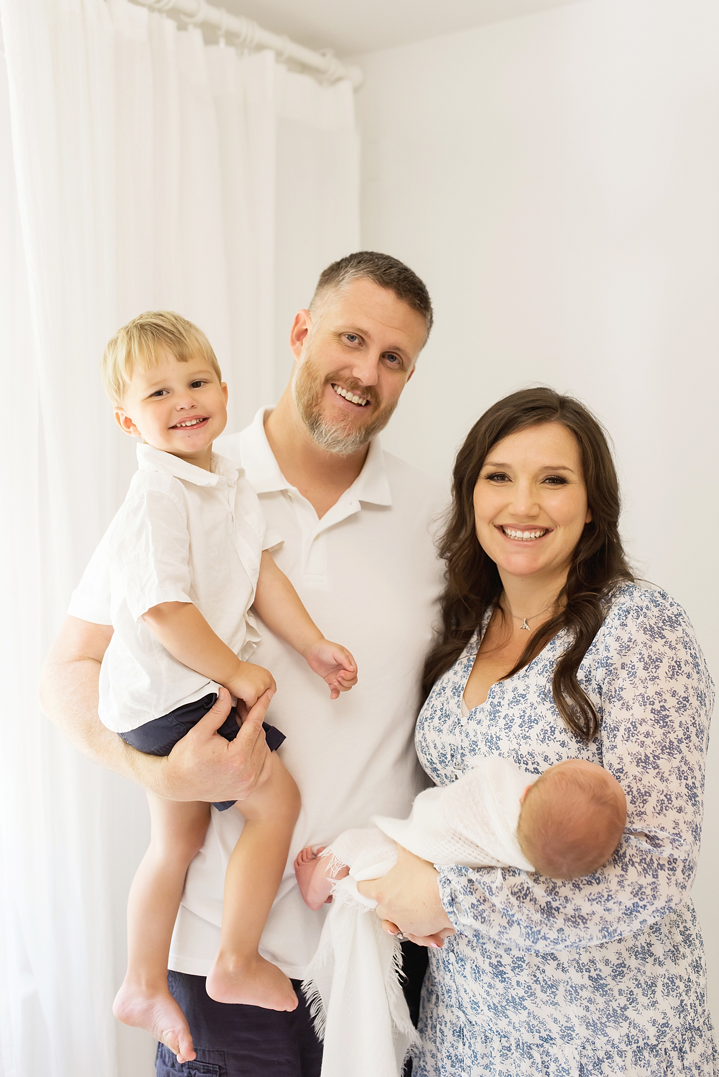 Family of four smiling | Photo by Denver NC Newborn Photographer Anna Wisjo Photography