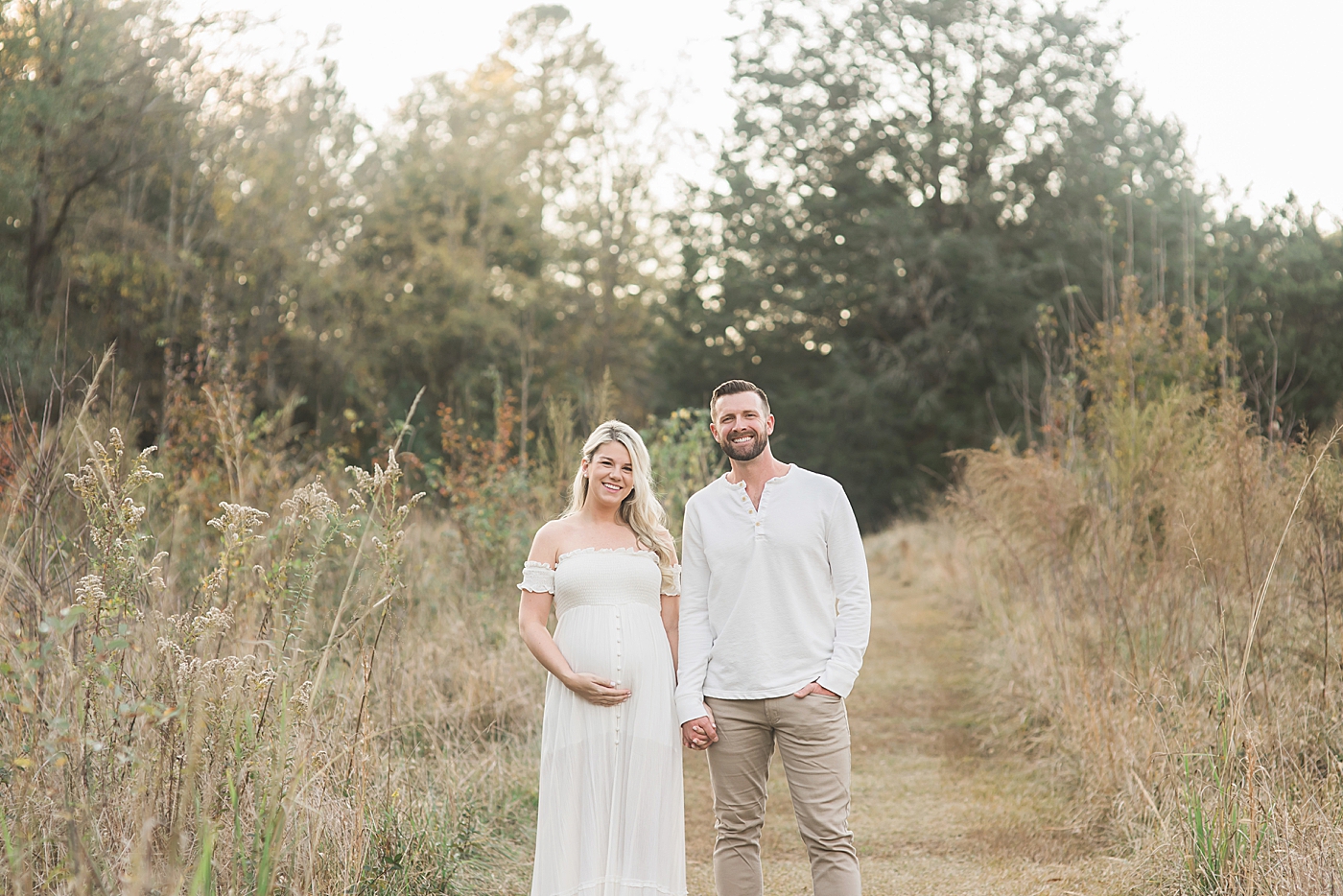 Couple in white during maternity session | Photo by Anna Wisjo