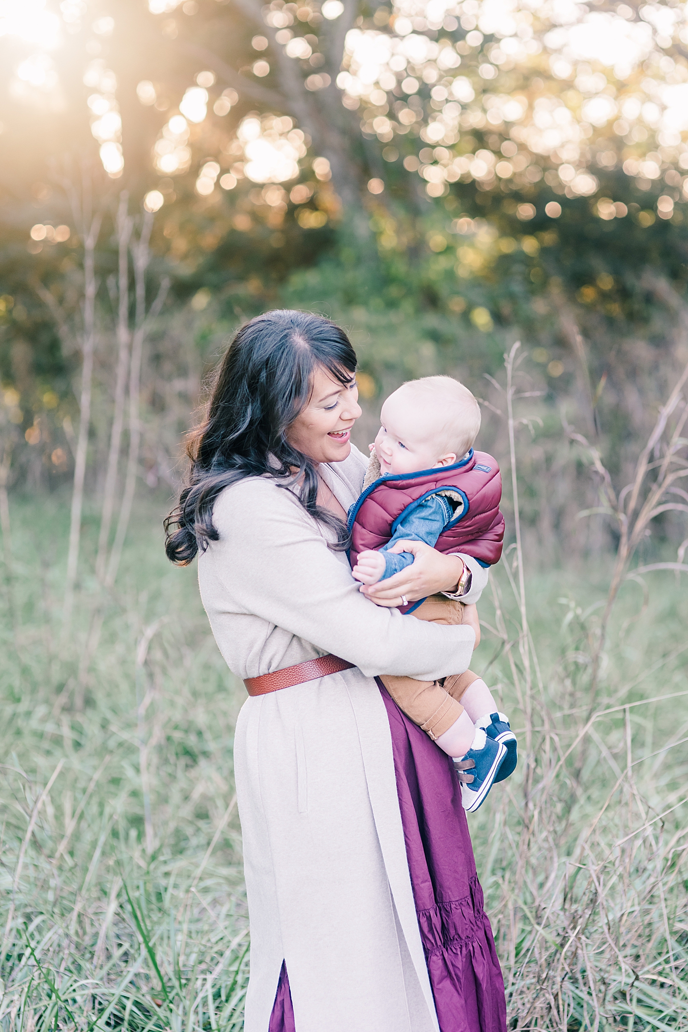 Mom in purple snuggling with baby boy | Photo by Anna Wisjo Photography