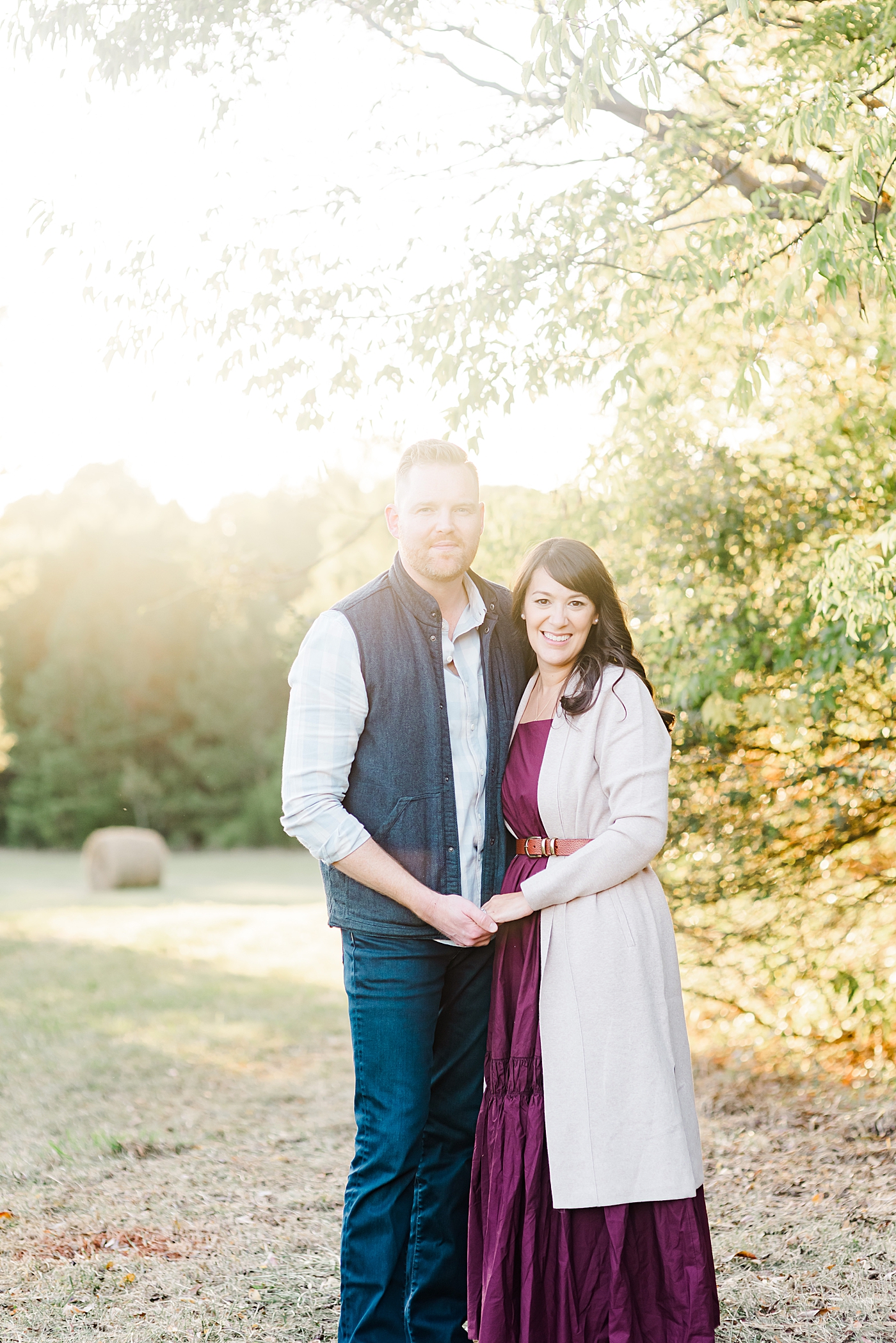 Mom and dad smiling holding hands | Photo by Davidson Milestone Photographer Anna Wisjo