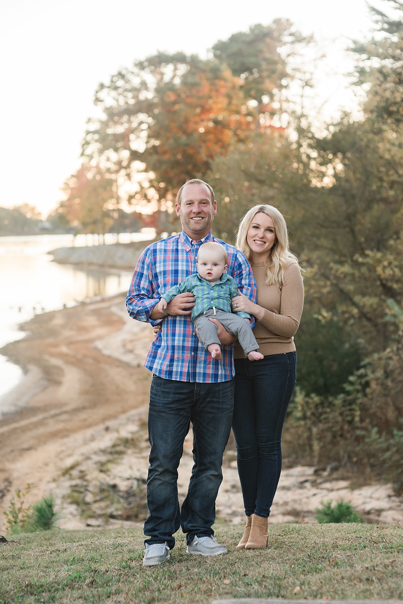 Mom and dad with baby boy by the lake | Photo by Denver NC Milestone Photographer Anna Wisjo 