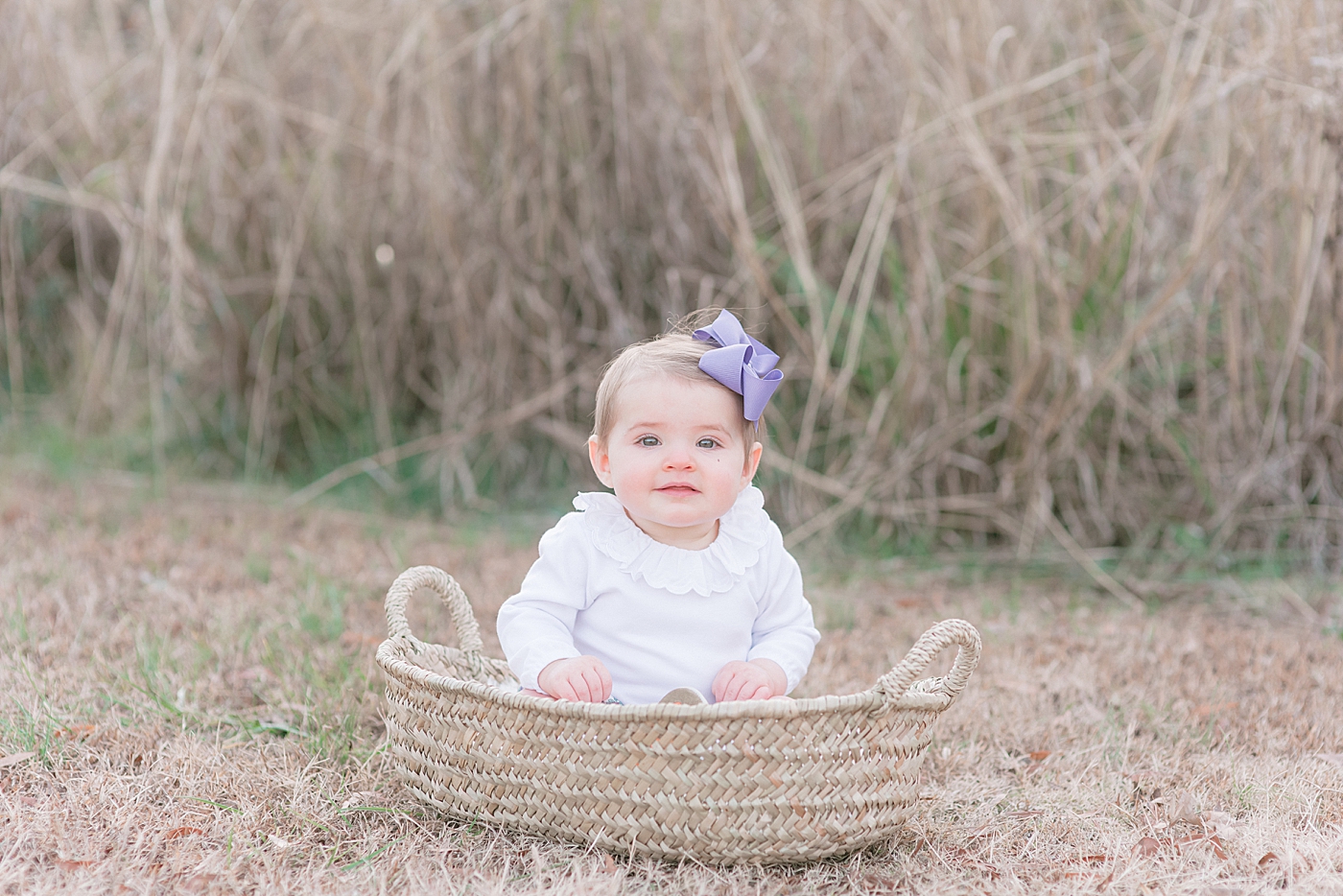 Baby sitting in a basket during her Milestone Session at Marvin Efird Park | Photo by Anna Wisjo Photography