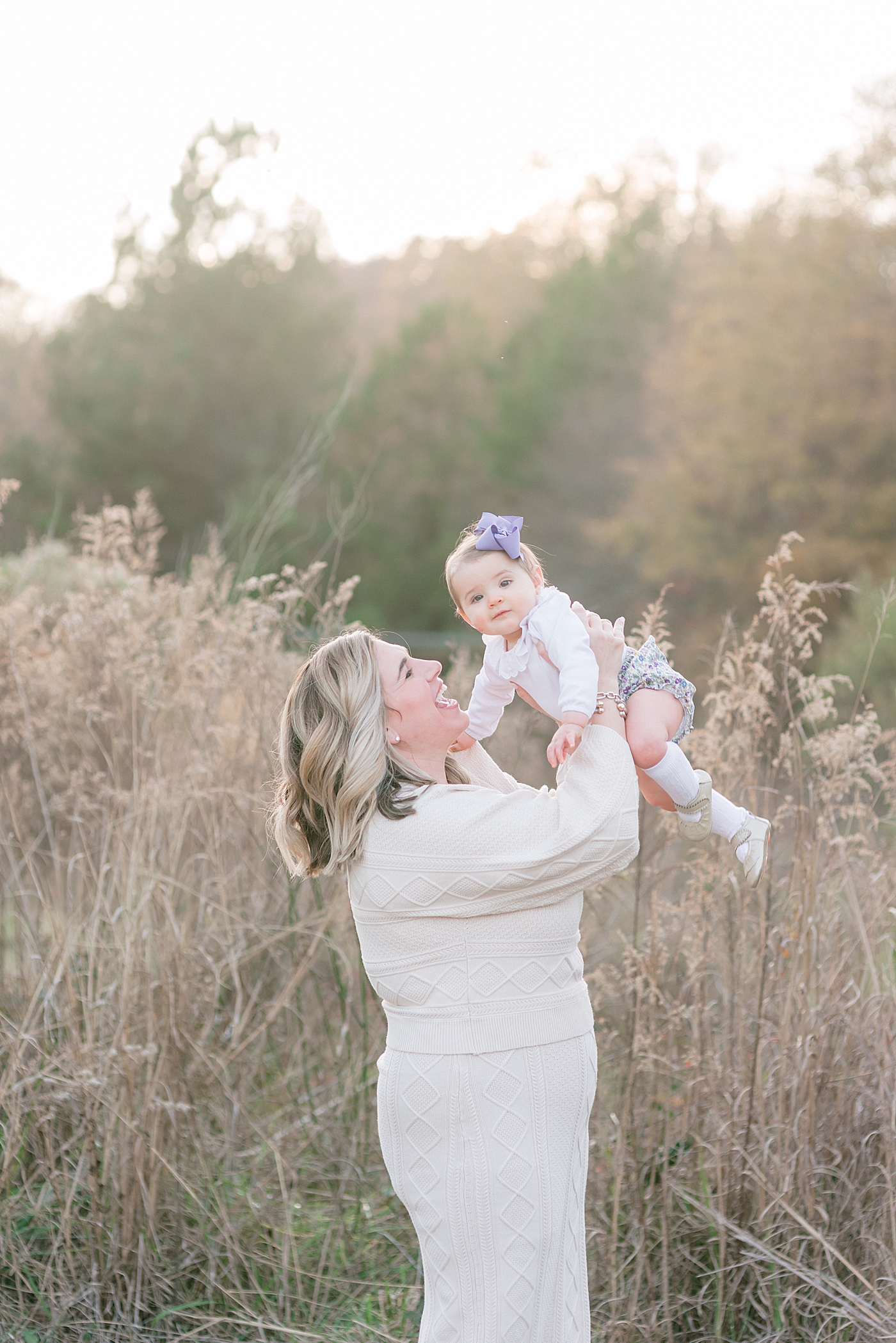 Mom playing airplane with baby girl in floral bloomers | Photo by Anna Wisjo Photography 