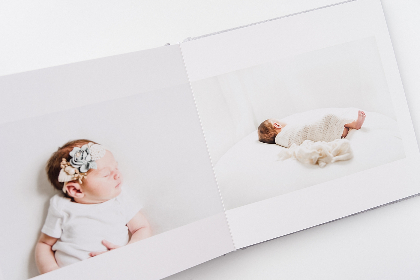 An album spread with a newborn baby girl | Photo by Anna Wisjo Photography