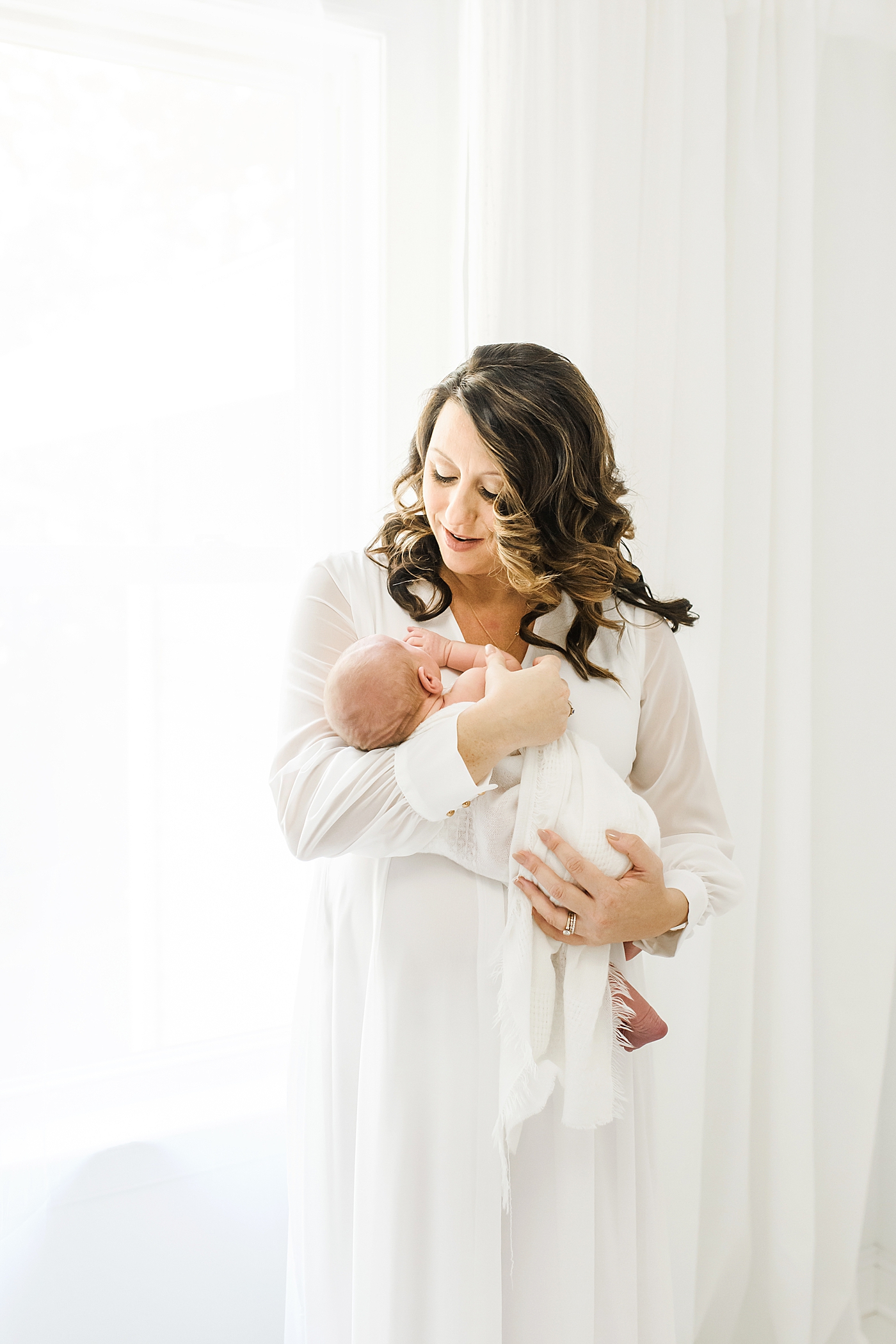 Mom in long white dress holding her new baby | Anna Wisjo Photography - Baby Photographer Charlotte