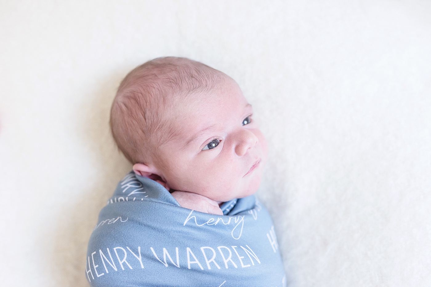 Newborn baby in custom swaddle | Photo by Anna Wisjo Photography