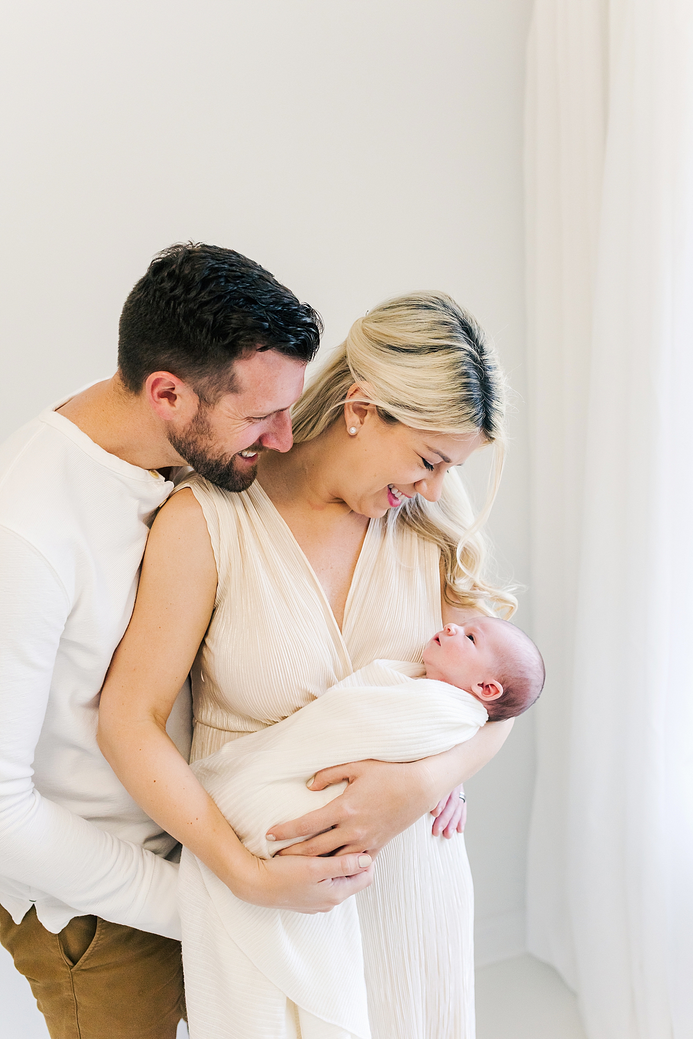 Mom and dad smiling at their new baby girl | Photo by Ballantyne newborn photographer Anna Wisjo 