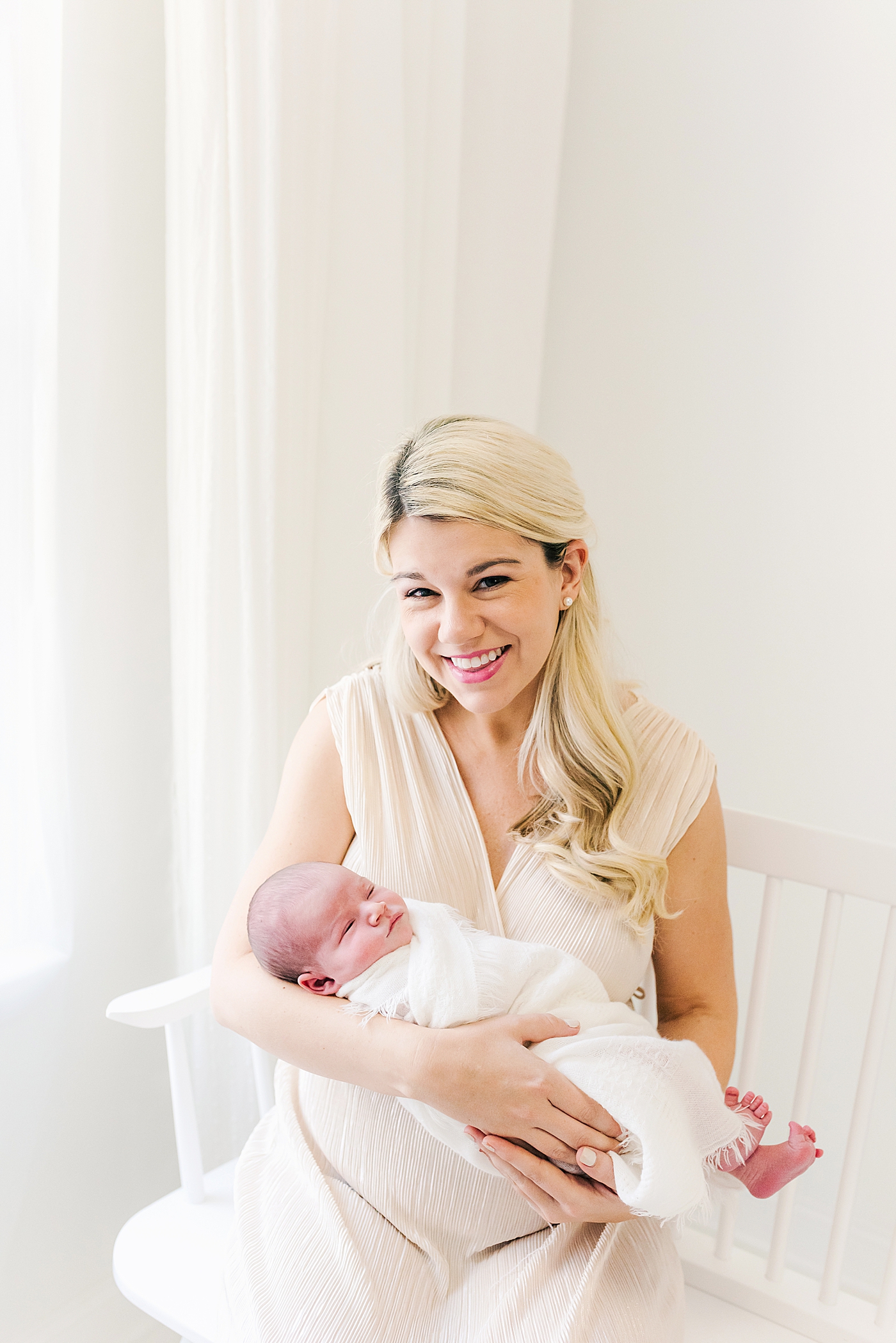 Mom in gold dress snuggling her new baby | Photo by Anna Wisjo Photography