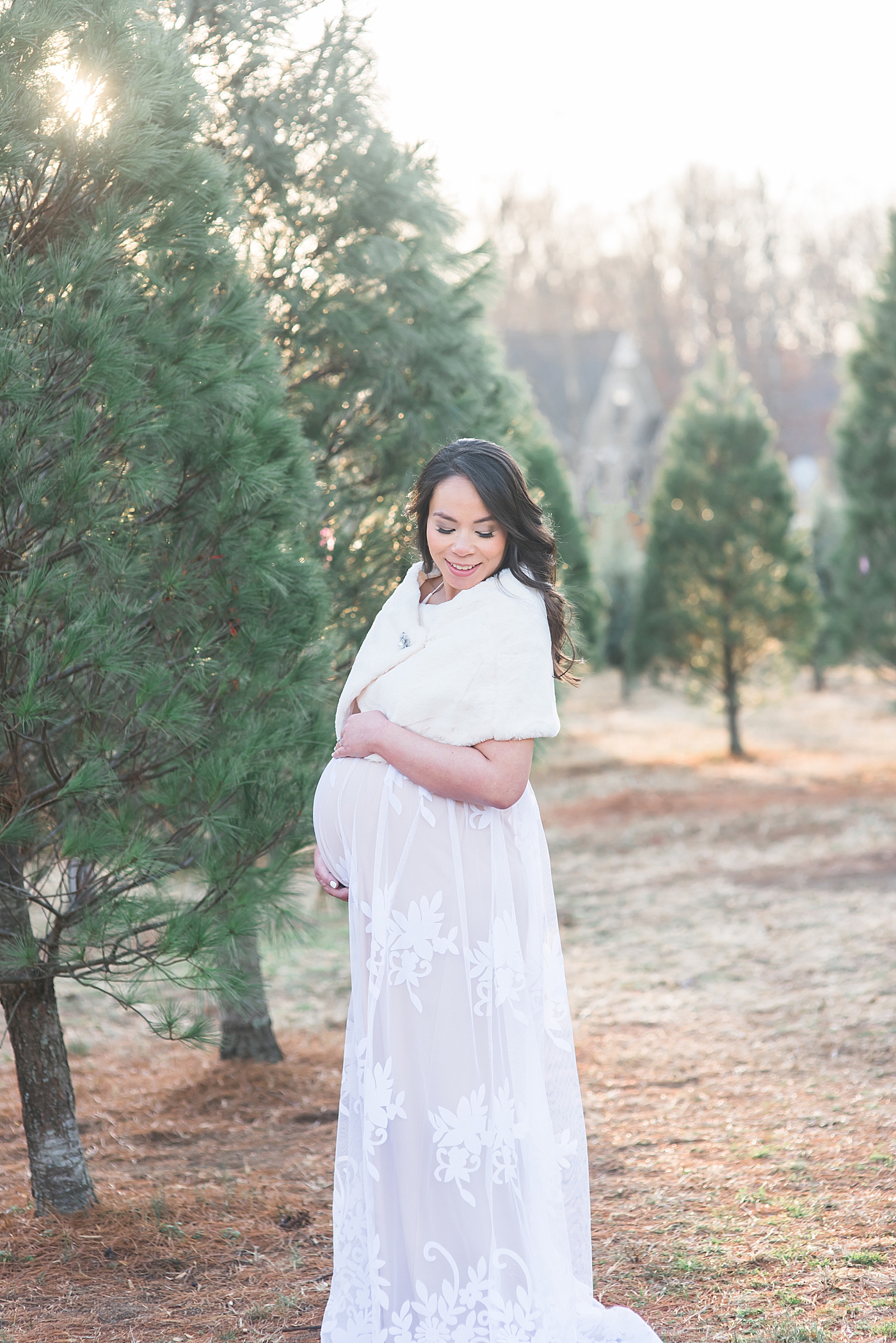 Mom to be in lace dress holding her belly | Photo by Anna Wisjo Photography