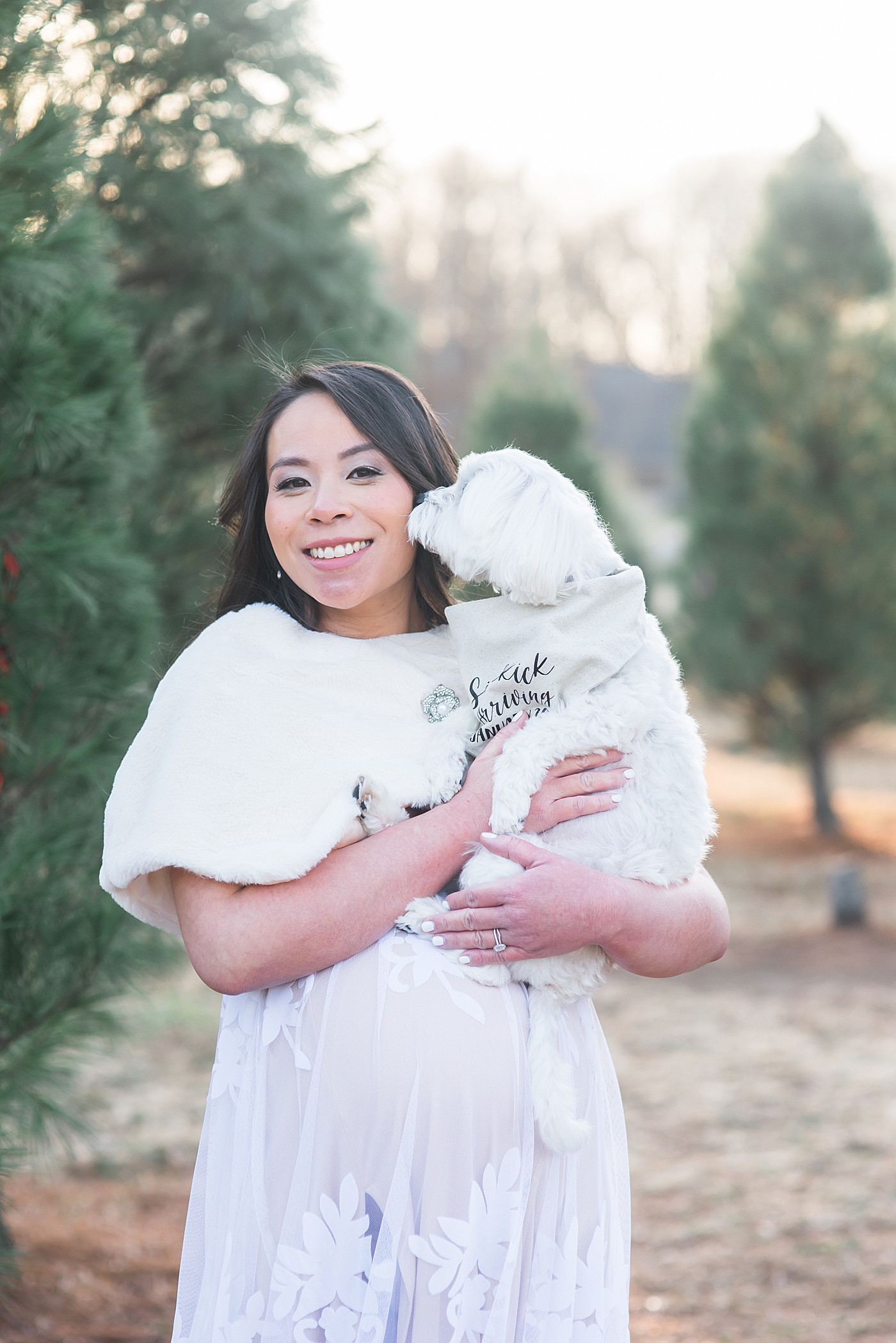 Mom to be holding her white puppy | Photo by Anna Wisjo Photography
