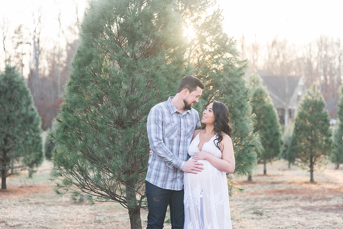 Mom and dad to be at a tree farm | Photo by Anna Wisjo Photography