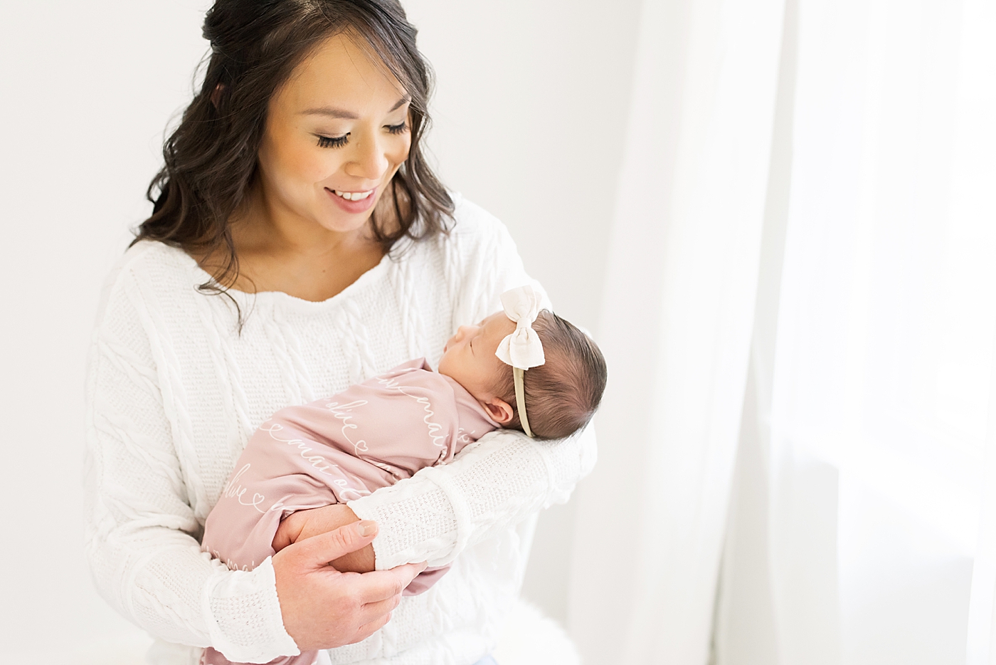 Mom holding her baby girl during newborn studio session| Photo by Anna Wisjo Photography
