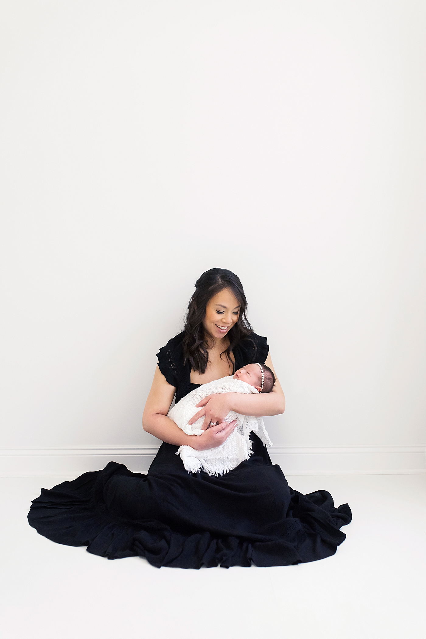 Newborn studio session for baby girl and mom in black dress | Photo by Anna Wisjo Photography