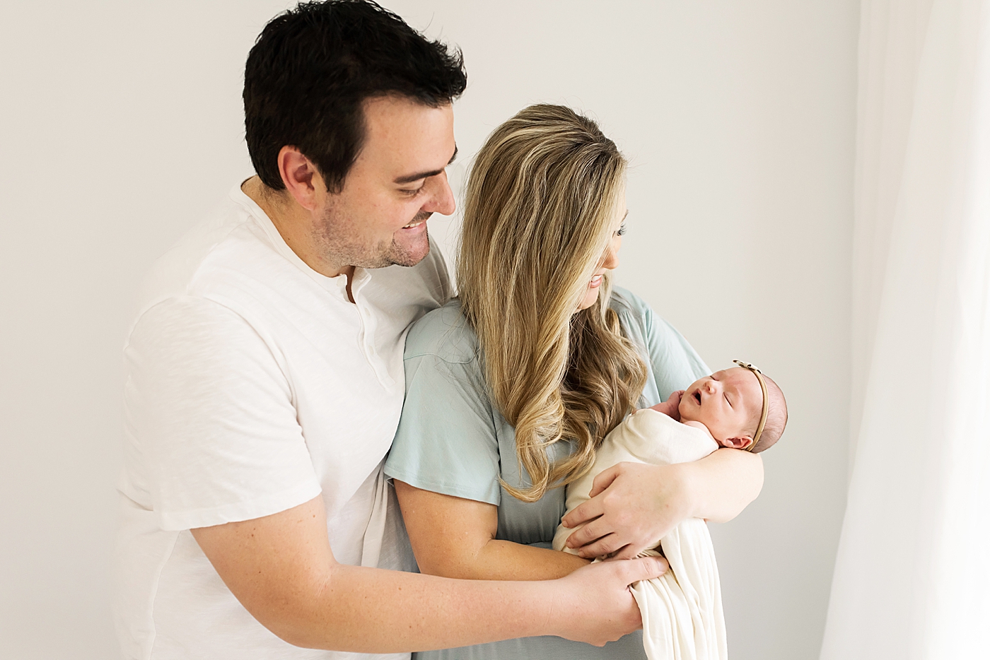 Mom and dad holding their new baby during their Studio Newborn Session in Denver | Photo by Anna Wisjo Photography 