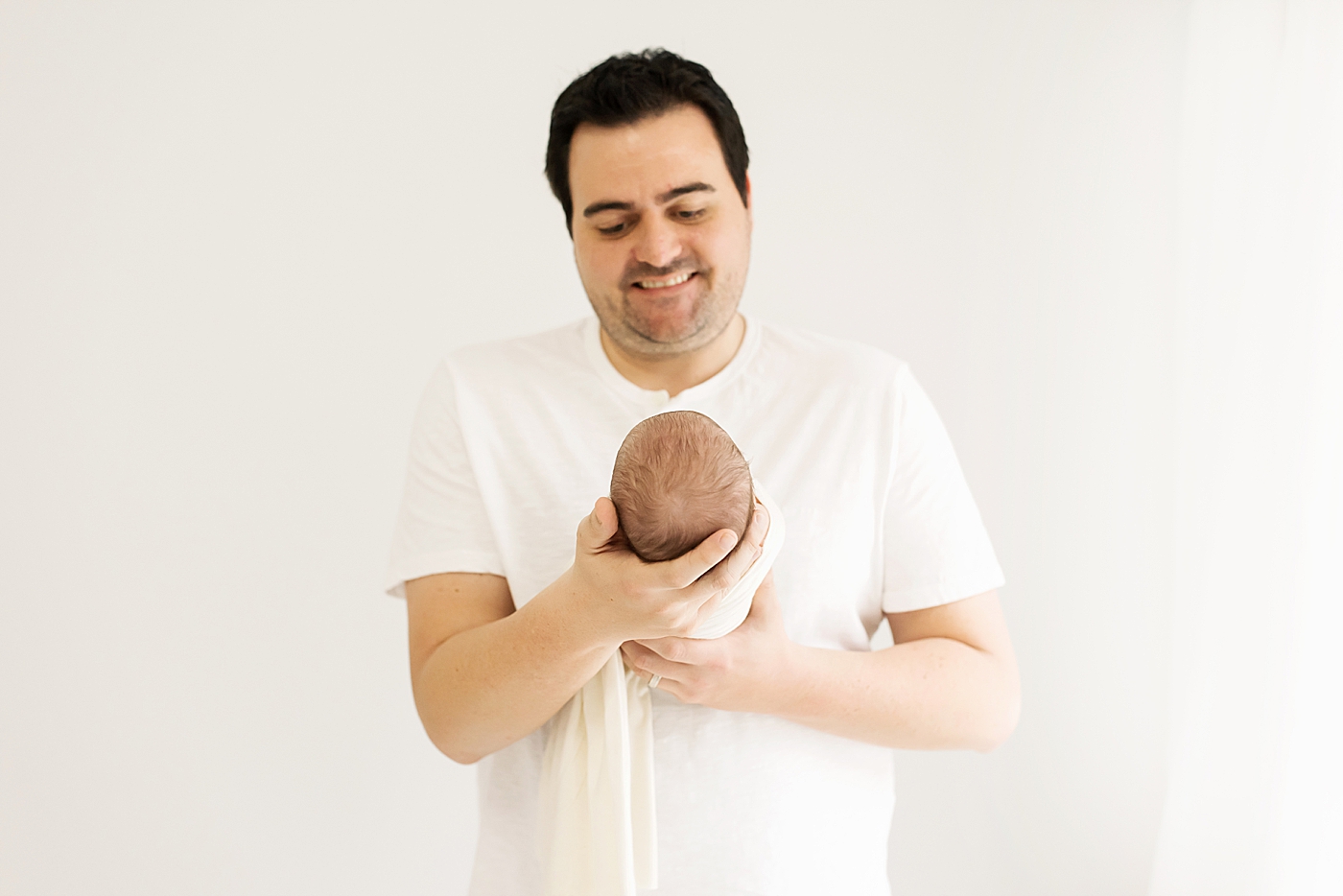 Dad holding his new baby girl during her studio newborn session in Denver || Photo by Anna Wisjo Photography 
