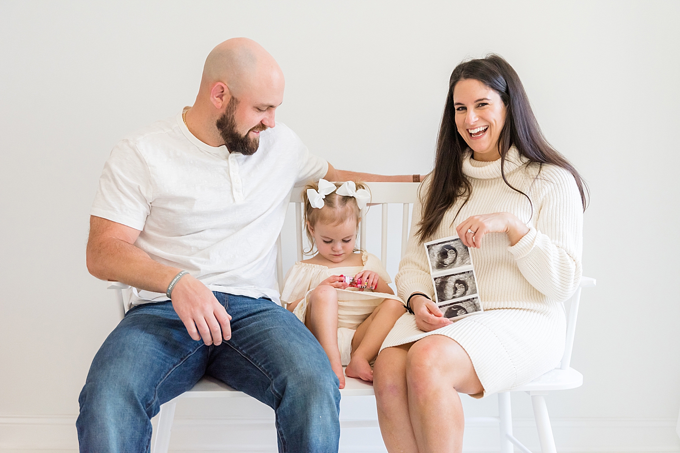 Family of three with ultrasound photos | Photo by Anna Wisjo Photography