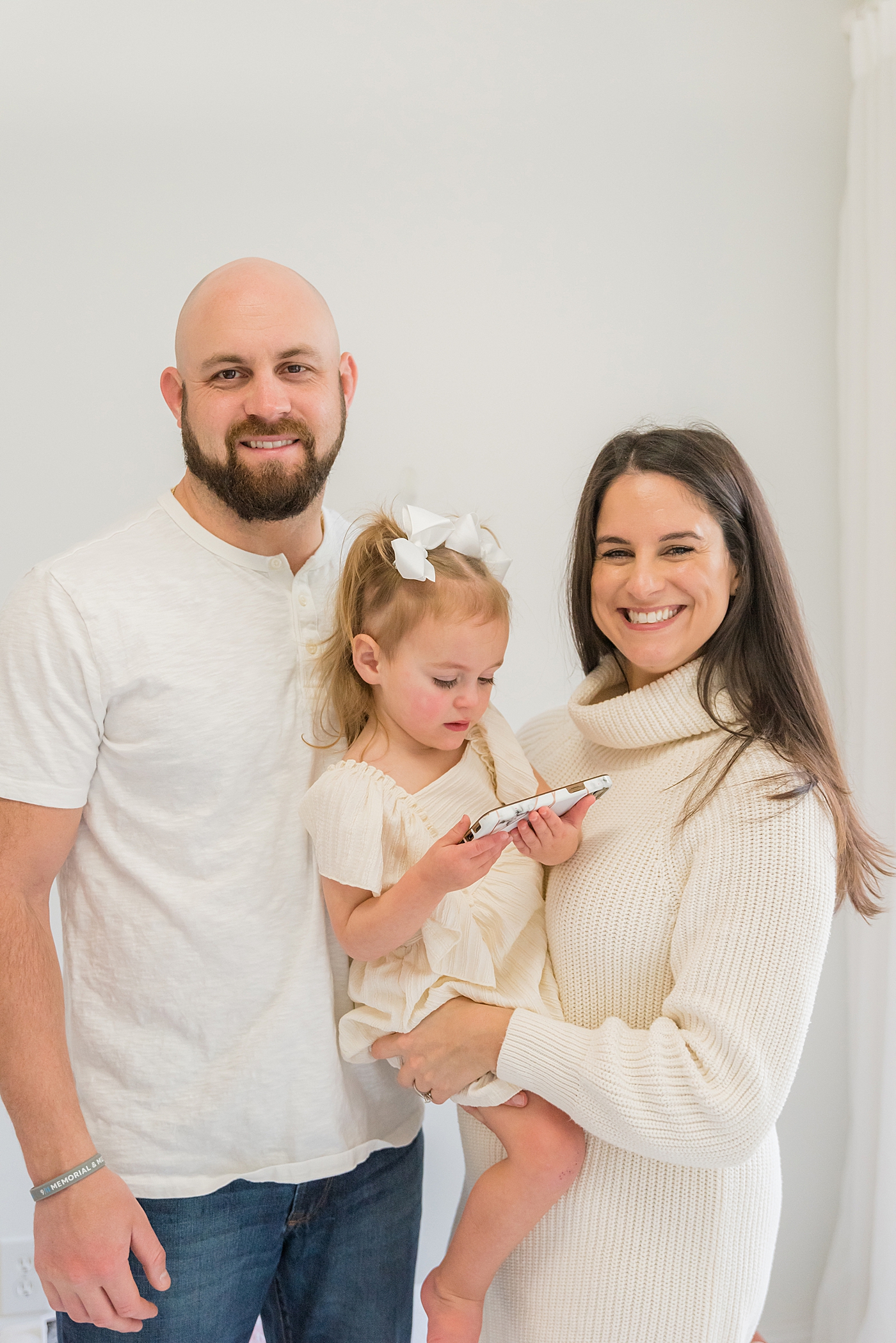 Family of three smiling | Photo by Charlotte Milestone Photographer Anna Wisjo Photography