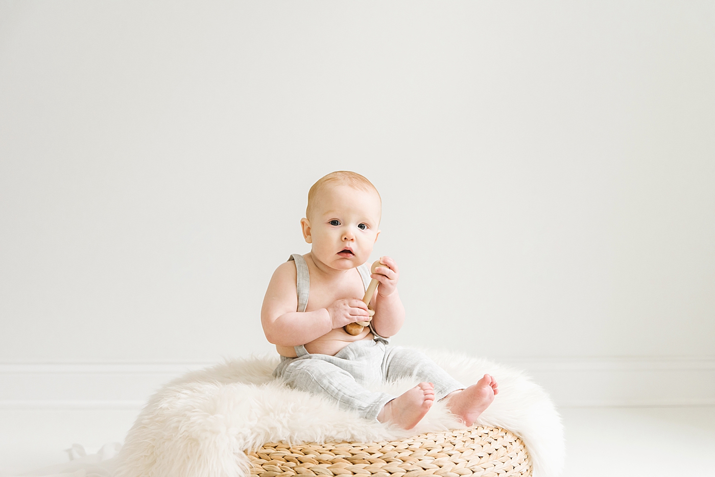 Baby boy playing with a wooden toy | Photo by Anna Wisjo Photography 