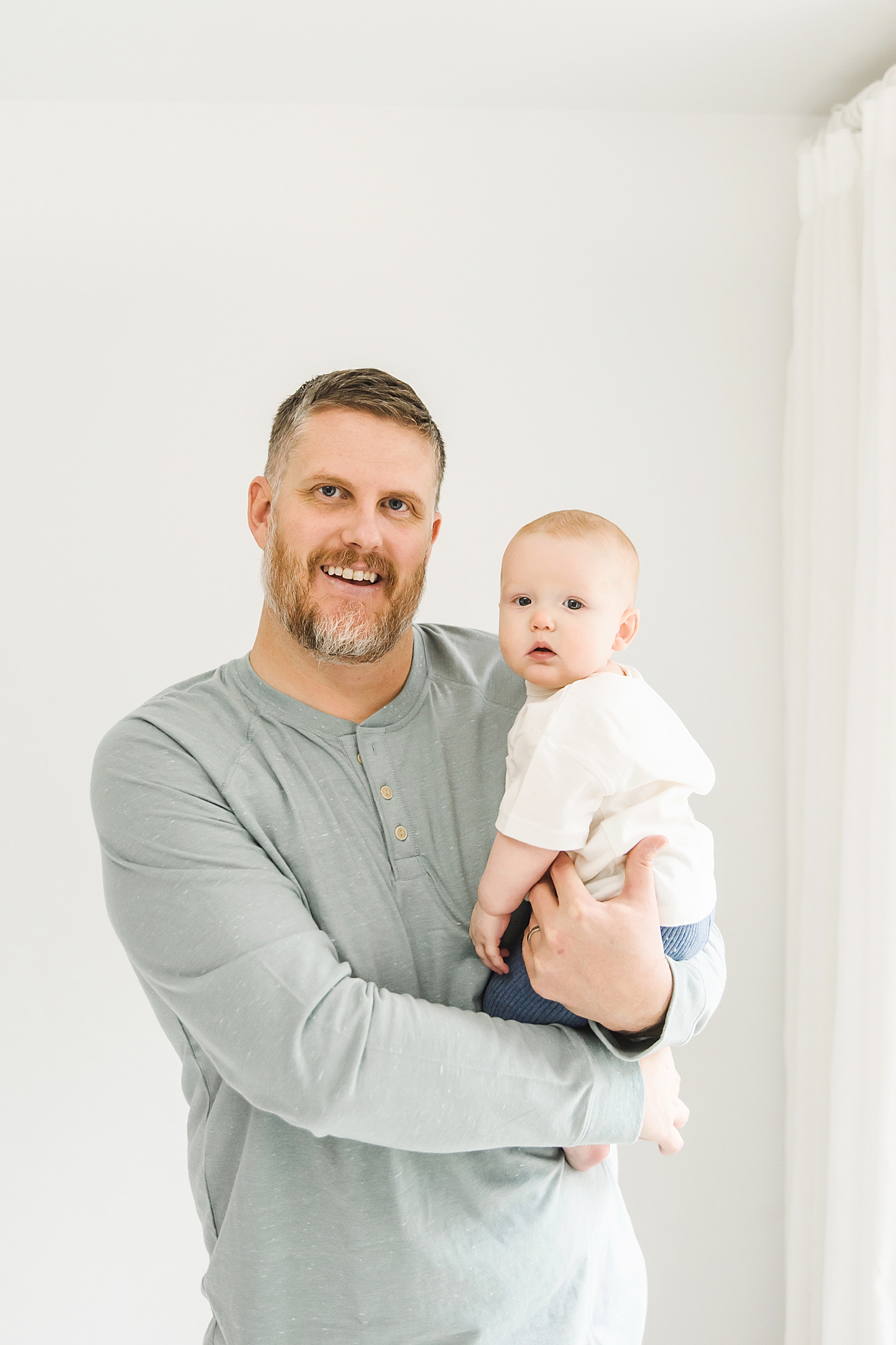 Dad and baby boy smiling | Photo by Denver NC milestone photographer Anna Wisjo