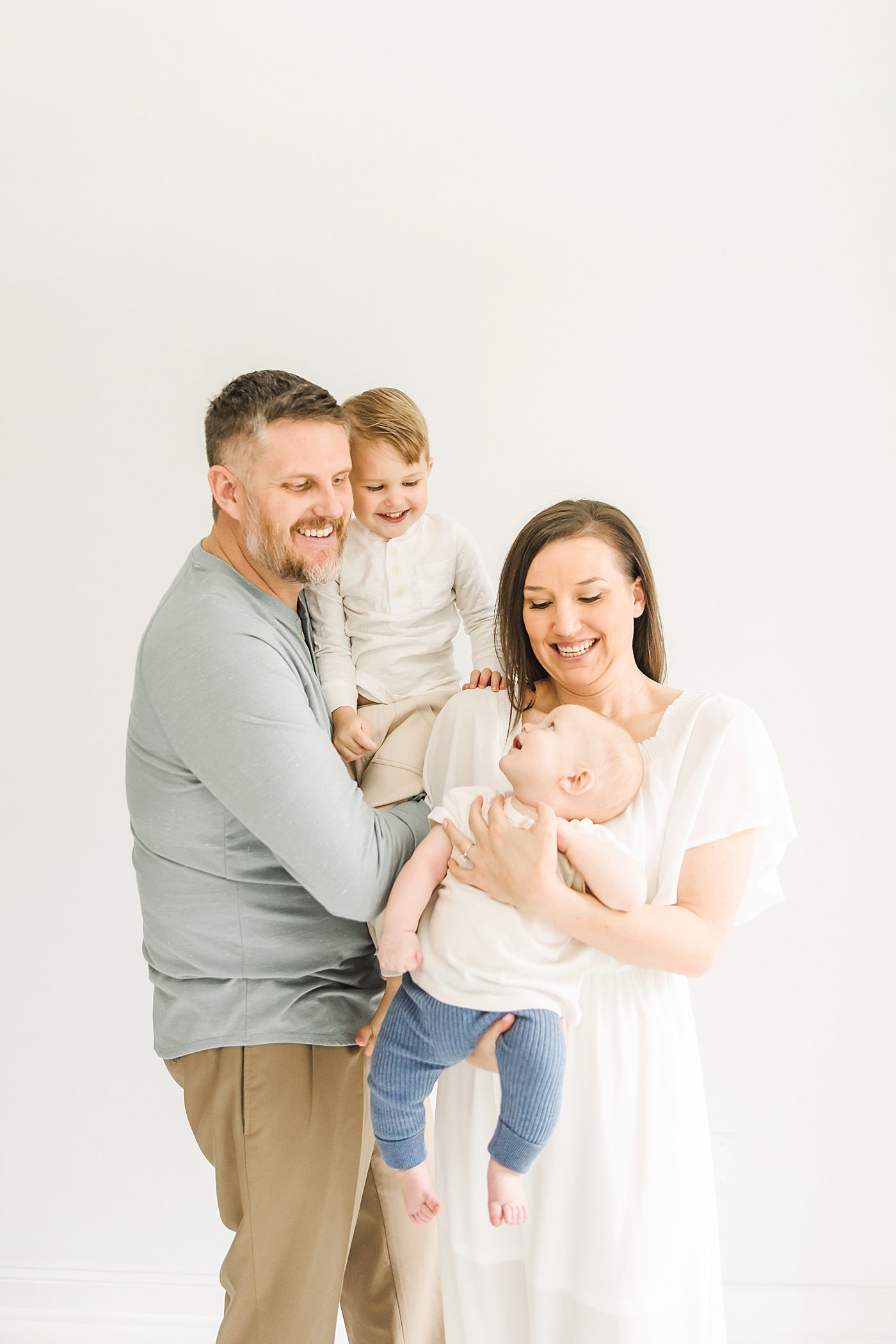 Family of four during studio session | Photo by Denver NC milestone photographer Anna Wisjo